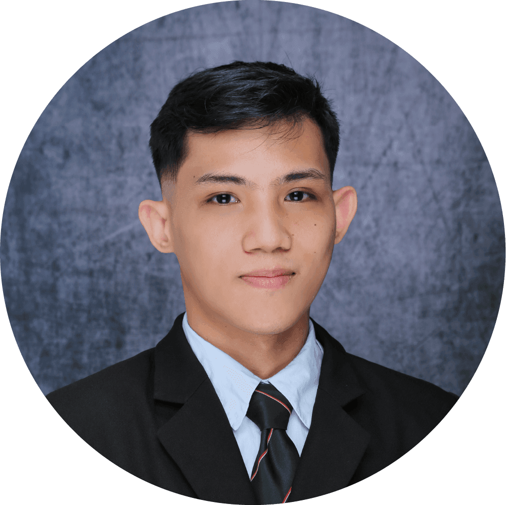 Graduation photo of Arche Angana in a black suit with tie